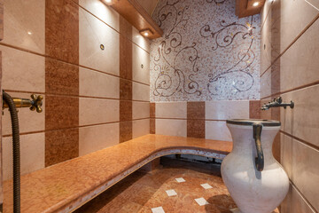 Luxurious steam room interior with marble and decorative tile finishes in a wellness spa