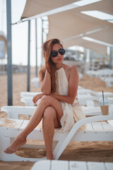 young woman sitting on the beach