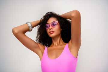 Fashionable young woman in a vibrant outfit posing confidently in a chic setting, highlighting...