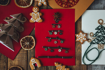 Flat lay. Handmade Christmas card with wool embroidered new year tree on craft recycled paper....