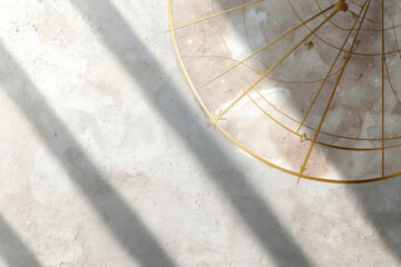 Astrology chart detail with gold celestial lines on soft marble background