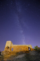 A view of the stars of the Milky Way with a mountain top in the foreground. Night sky nature summer...