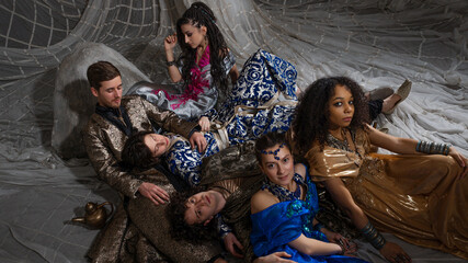 Middle Eastern fairytale group shot, models in luxurious Arabic attire against exotic backdrop