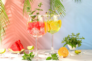 Modern still life with alcoholic cocktail of watermelon, lemon, ice, tequila, vodka and mint on...