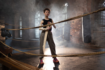 A woman in a boxing ring, wrapping an elastic bandage around her arms, preparing for boxing training. The photo is in a cinematic style, the light gives the mood to a sports motivational story about