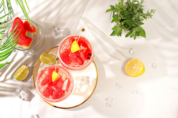 Ice punch with watermelon slices, lemon, mint, ice with tequila, vodka or soda water on elegant...