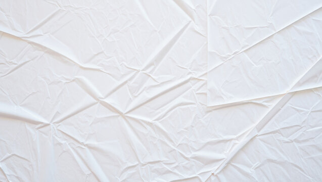 Top-down view of a crumpled white paper sheet creating a detailed abstract texture background under soft, even light
