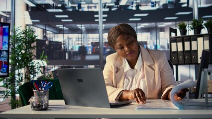 Determined female CEO analyzes financial reports and develops a growth strategy to increase income,...