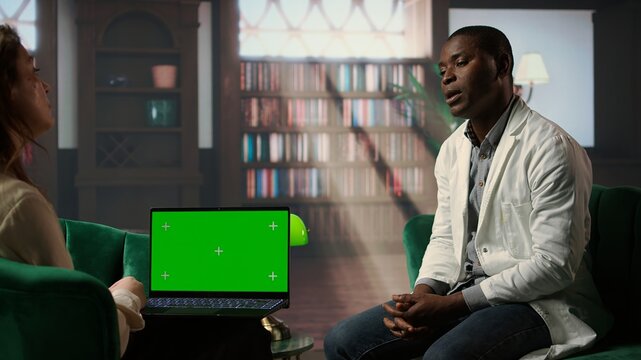 Professional counselor holds a copy space tablet in therapy session with medic, consulting doctor with trauma after losing patients. Discussing stress disorder and anxiety in his career. Camera A.