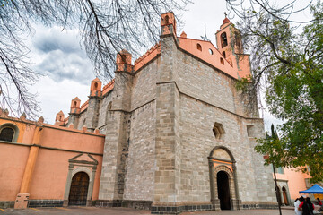 Front view of historic stone cathedral with towers and visitors in Tula de Allende, Mexico