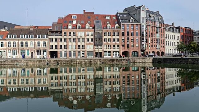 Lille, France - 15 October 2024 - Scenic Reflection of Historic Buildings on a Tranquil Waterway at Le quai du Wault ( Le quai du Wault ) one of the two old ports of Lille, France