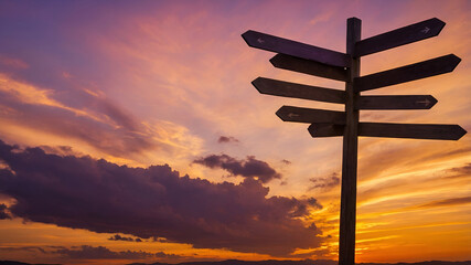 A signpost under the open sky points to paths of choice, travel, and change — guiding the journey through direction, meaning, and possibility toward the future.