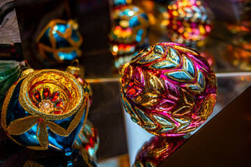 Christmas decoration with a mirror shine in the foreground lie on the edge of the table in a...