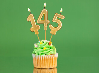 Birthday card with candle and cupcake - Number 145 on a green background