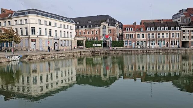 Lille, France - 15 October 2024 - Scenic Reflection of Historic Buildings on a Tranquil Waterway at Le quai du Wault ( Le quai du Wault ) one of the two old ports of Lille, France