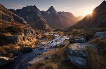 Mountain landscape with winding river through golden meadow at sunset with dramatic clouds