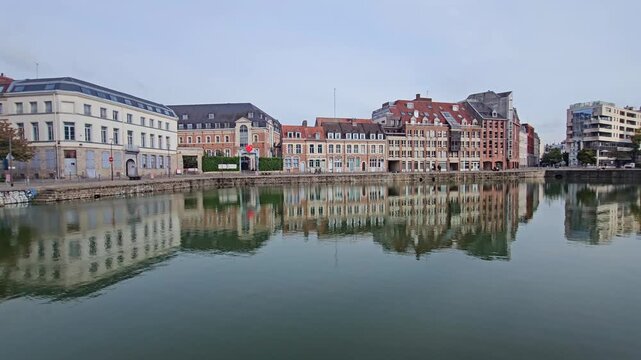 Lille, France - 15 October 2024 - Scenic Reflection of Historic Buildings on a Tranquil Waterway at Le quai du Wault ( Le quai du Wault ) one of the two old ports of Lille, France