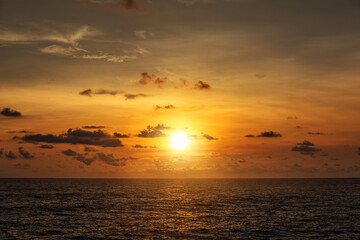 Golden Sunset Reflecting on Peaceful Ocean Shore