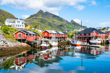 Typical traditional houses in Sorvagen port and fishing village in summer mountain landscape, Lofoten Islands, Norway © pkazmierczak