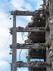 Urban demolition reveals skeletal structure of a once-thriving building amid overcast sky