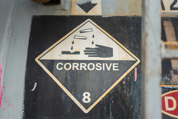 Acidity corrosion or skin burn hazard, safety sign on the chemical containment barrel. Sign and...