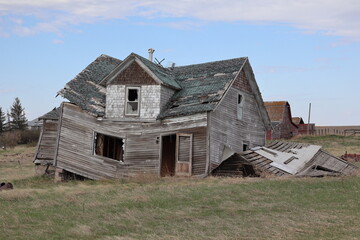 The old house is slanted and falling over because of it has been abandoned and neglected. The...