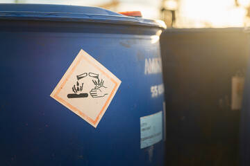 Acidity corrosion or skin burn hazard, safety sign on the chemical containment barrel. Sign and...
