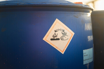 Acidity corrosion or skin burn hazard, safety sign on the chemical containment barrel. Sign and...