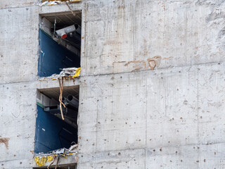 Construction site reveals unfinished concrete structure with exposed walls and materials in urban...