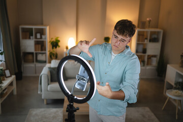 man v-logger set up mobile phone and ring light for live streaming