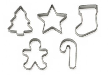 Metallic holiday cookie cutters displaying festive star, tree, and bell shapes resting on clear surface before baking