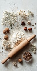 Fototapeta premium Flour, rolling pin, nuts, spices, & flowers on light surface