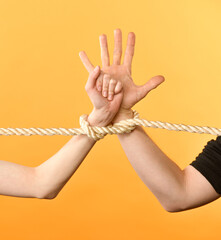 female and male hands with rope