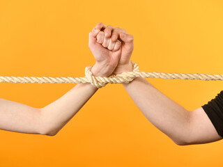 female and male hands with rope
