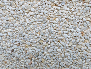 Top view close-up of exposed aggregate surface with gravel stone in off-white and ochre tones with...