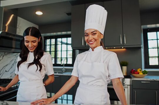 Professional chefs showcase culinary skills in modern kitchen setting with fresh ingredients