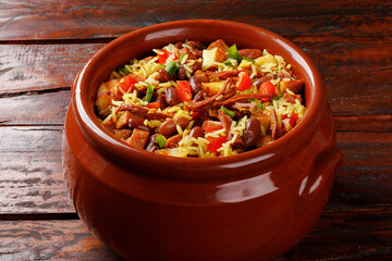 Baião de Dois in a ceramic casserole, a typical dish of Brazilian northeastern cuisine with rice, beans, jerked beef and curd cheese