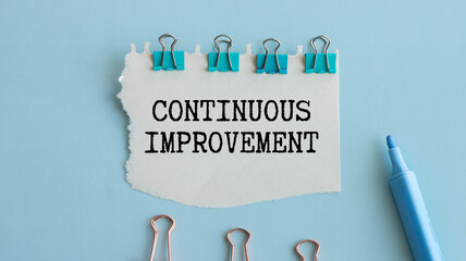 Torn paper with text Continuous Improvement.