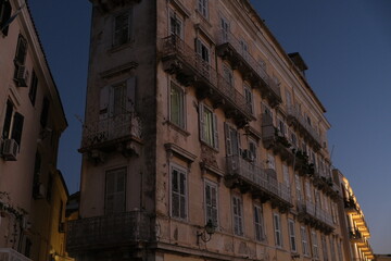 Exploring the vintage facade of buildings in the old town of corfu at twilight