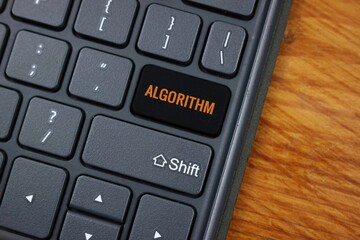 Keyboard Featuring Custom Algorithm Key on Wooden Surface
