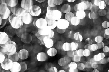 Numerous bright, soft-edged circles overlap in this grayscale abstract image, forming a luminous...