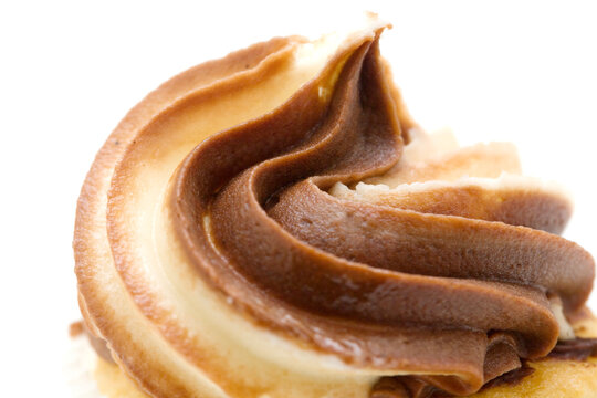 Extreme macro image of a cupcake with rich chocolate and vanilla swirl frosting.