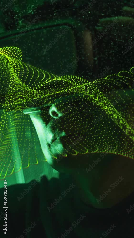 Poster animation of digital wave patterns flowing over person in dark environment