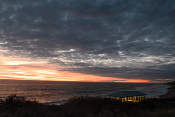 Sunset at Port Willunga. A shelter is lit up showing a contrast from the beachside views.