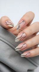 Close-up of a woman's hand showcasing a trendy, minimalist clear nail design featuring elegant wavy black lines on long, manicured nails, reflecting modern beauty and style