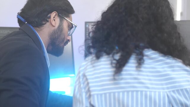 Two female software developers in a pair programming session, debugging complex code on a screen. Concept for agile development, code review, and problem-solving in tech.