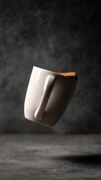 Vertical video floating cup of coffee on a black background, white ceramic hot coffee cup with steam float up from cup on dark background