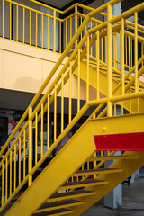 Background of a Bright Yellow Staircase and Railing at a Shopping Mall.