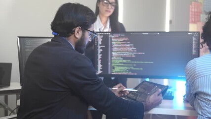 A dedicated IT team collaborates in a command center, working on a critical software deployment or incident response. Concept for system implementation, teamwork, and operations.