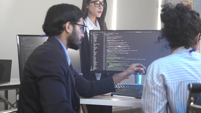 A senior software engineer leads a code review session, mentoring his diverse team on a complex project. Concept for agile development, knowledge transfer, and teamwork.